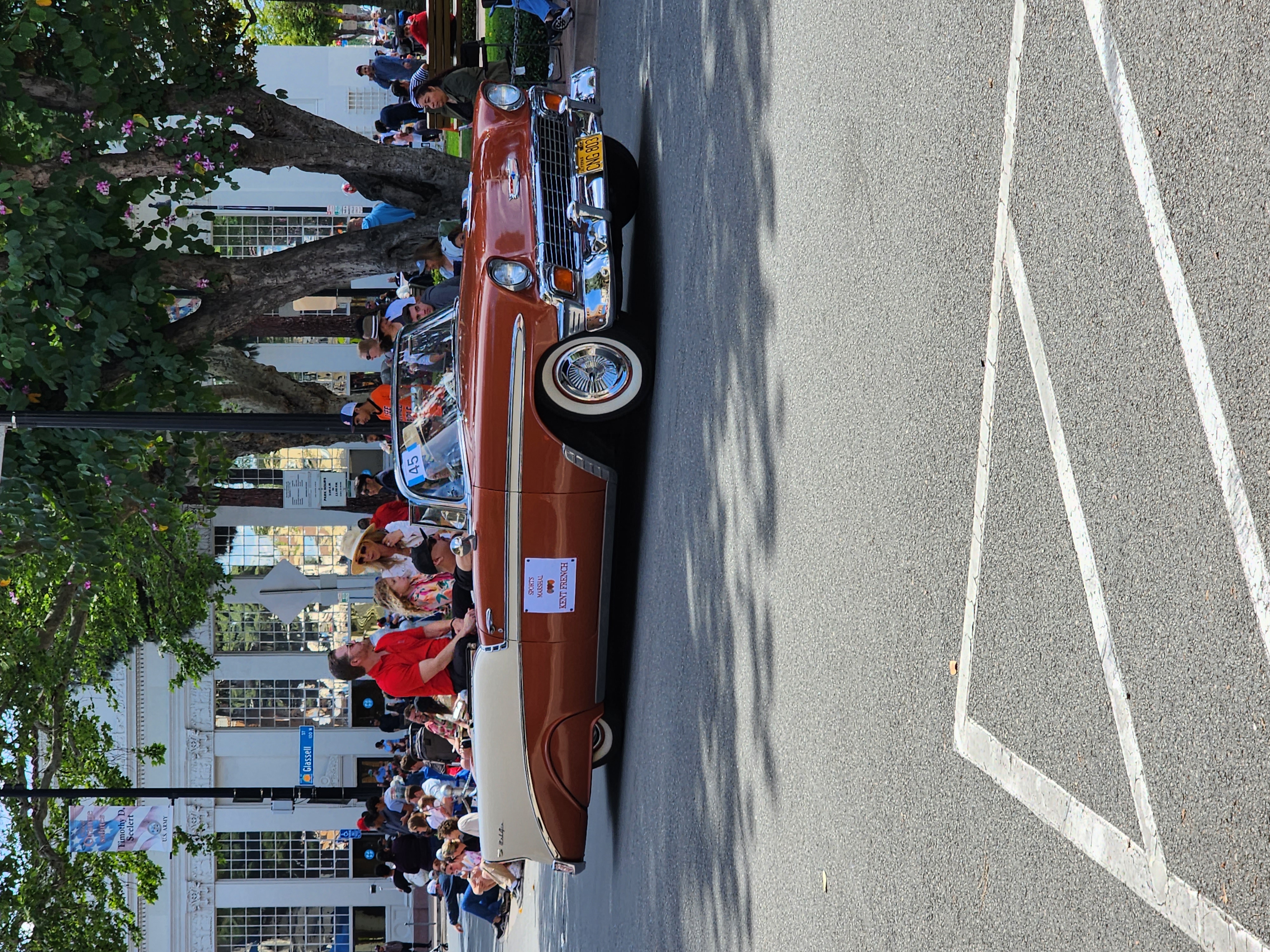Classic car in the Old Town Orange parade passing the historic Plaza bank building